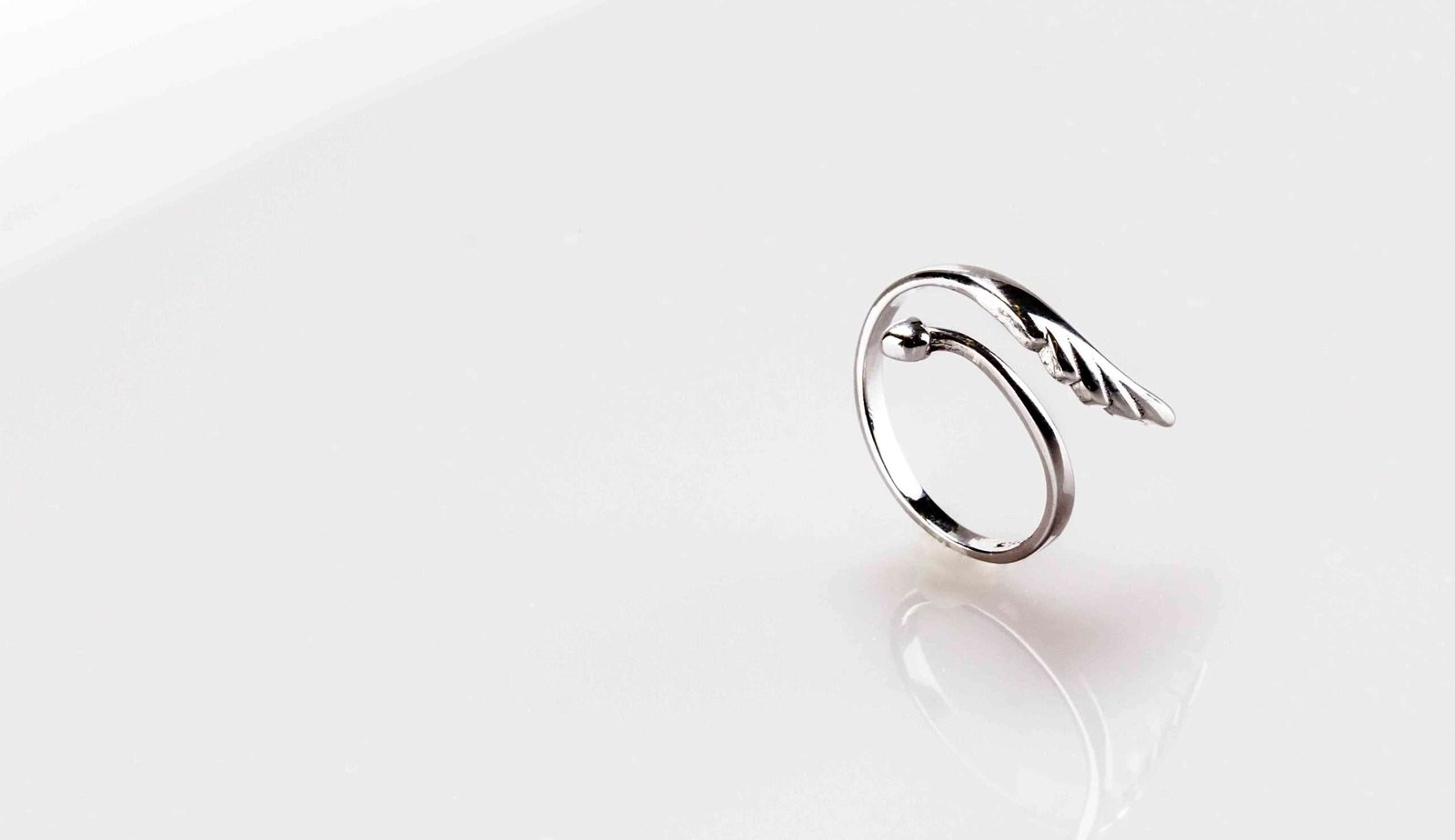 Silver band ring on a white table