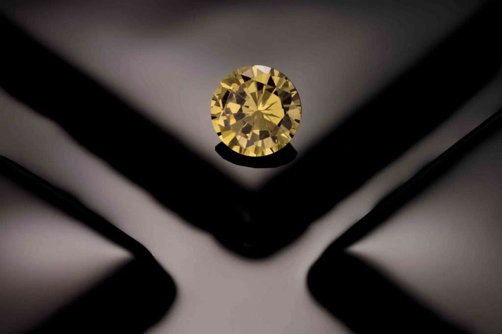 Round yellow gemstone on a black background