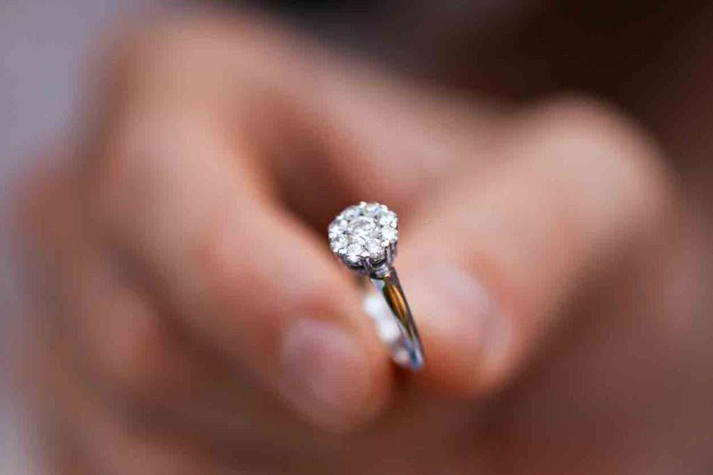 Close-up of a silver diamond ring in a man's hand