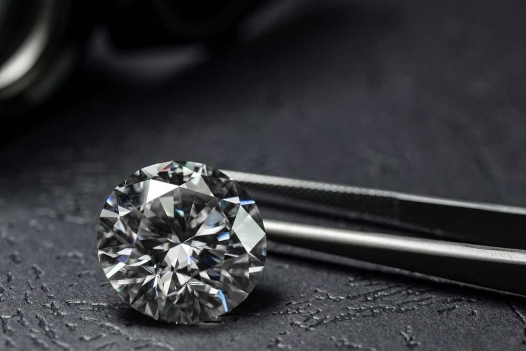 Diamond beside tweezers
