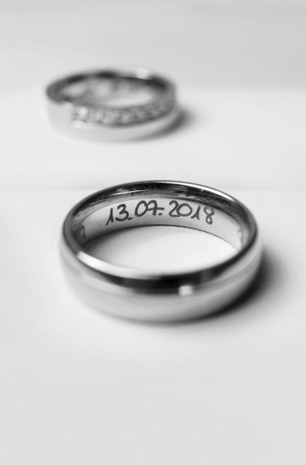 Engraved band ring on a white table